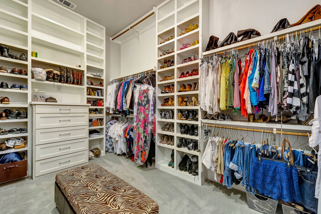 Modern custom closet interior with organized shelves and hanging rods in a Bradenton home.
