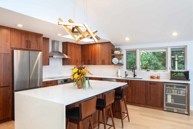 Modern kitchen interior with updated cabinets, countertops, and island.