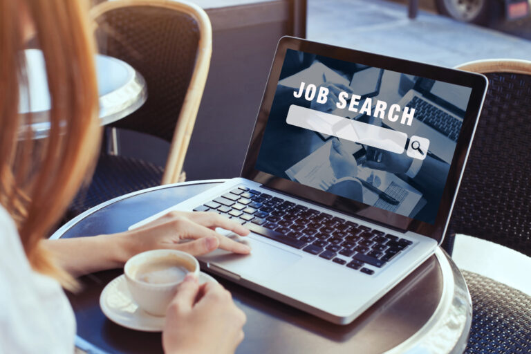 Woman using computer to browse job opportunities on an online job portal website for career search